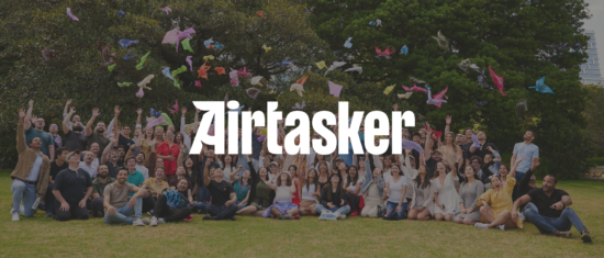 Airtasker team celebrating outdoors, throwing colorful fabric above them in a joyful group photo., Airtasker group photo, Celebration outdoors