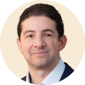 headshot of a man in a blazer with a neutral background, professional portrait, confident expression, corporate style