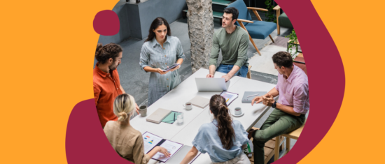collaborative team meeting around a table with laptops, discussing ideas in a modern office space, diverse group brainstorming with digital devices