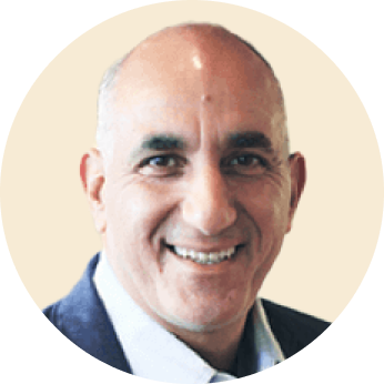 smiling man in a round frame wearing a suit against a light background, professional portrait with a welcoming expression