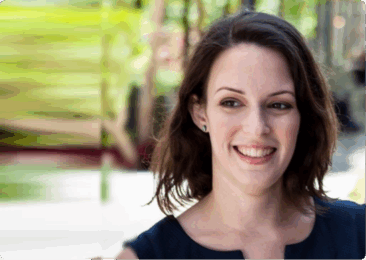woman smiling in a garden, green blurred background with soft lighting