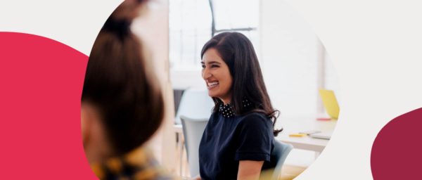 smiling woman in stylish outfit in bright work environment, casual office setting with modern furniture and colors