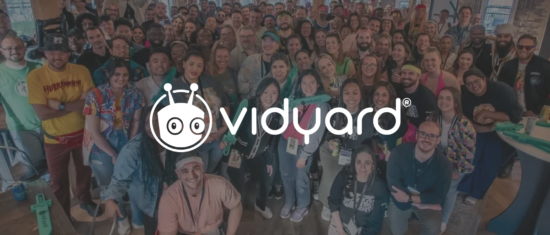 group photo of diverse Vidyard team members smiling at an event, showcasing vibrant attire and a lively atmosphere, Vidyard team event photo, diverse group of smiling individuals celebrating together