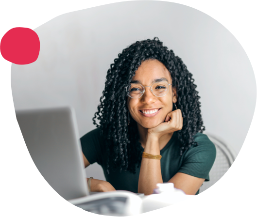 smiling woman with curly hair at laptop in modern workspace, businesswoman working remotely at home office